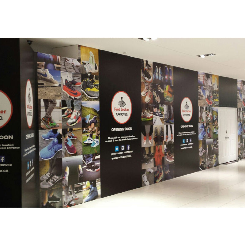 Hoarding graphics by Artsoft Expo Solutions Inc. featuring colorful, printed signage designed for construction site barriers.