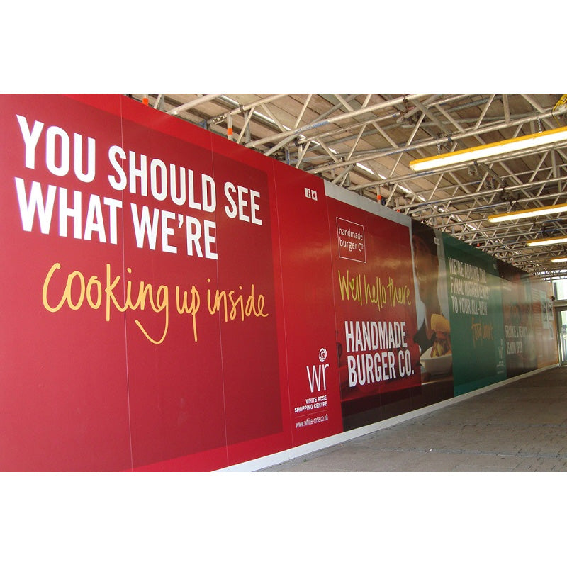 Hoarding graphics featuring colorful design by Artsoft Expo Solutions Inc. on a construction site hoarding.