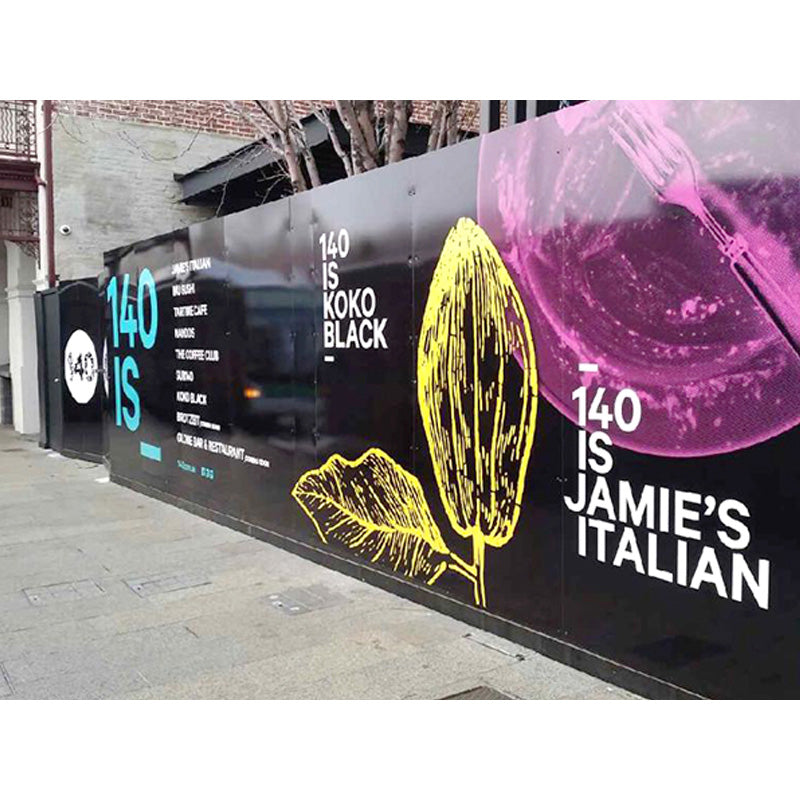 Hoarding graphics featuring bold, colorful designs on a construction site hoarding by Artsoft Expo Solutions Inc.