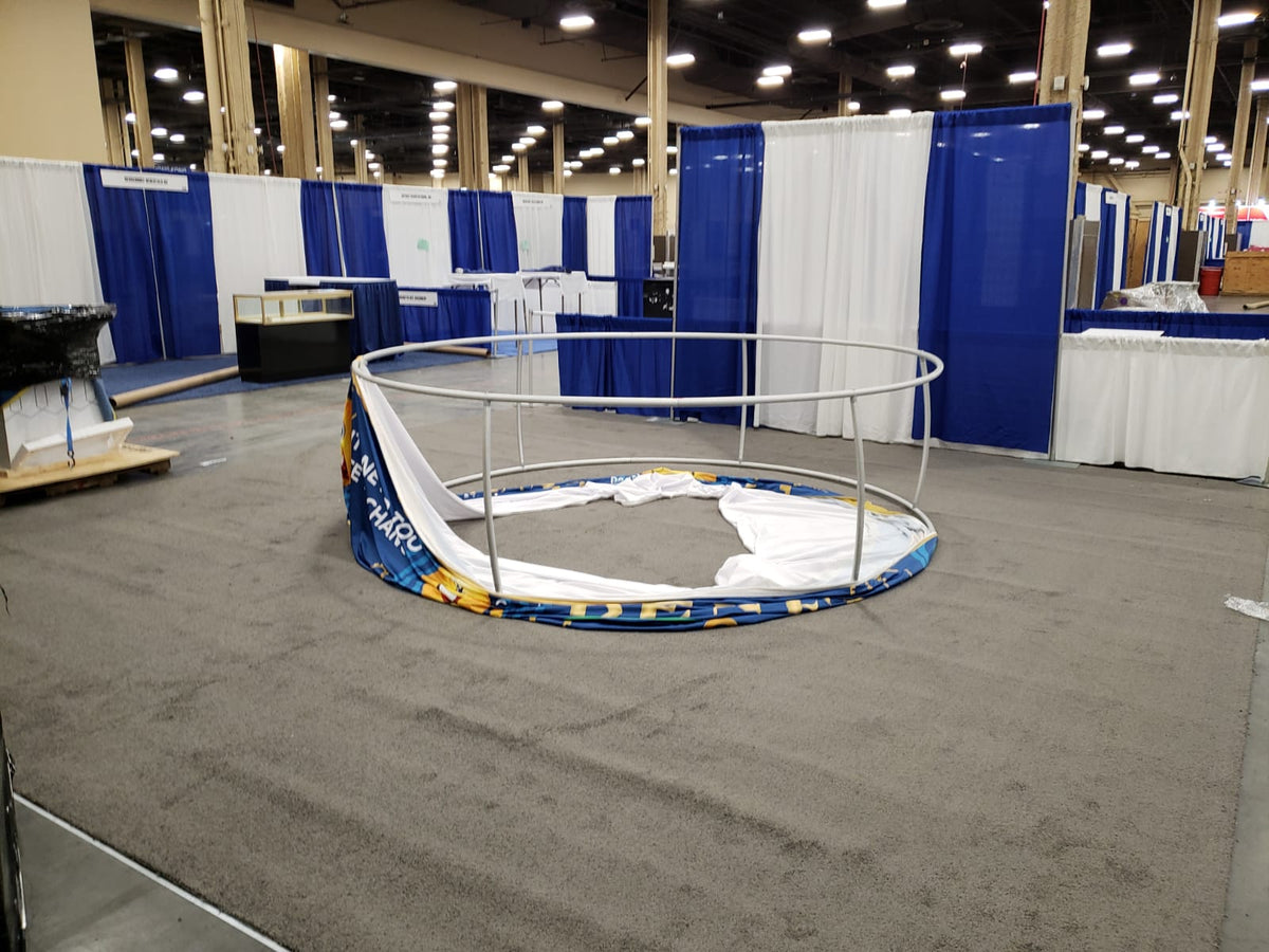 Round hanging sign by Artsoft Expo Solutions Inc. with a circular shape and mounting hole, suitable for display or signage.