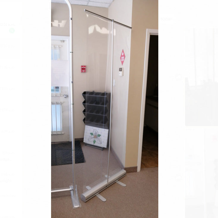 Clear retractable barrier by Artsoft Expo Solutions Inc. with a sleek, transparent design for safety and social distancing.