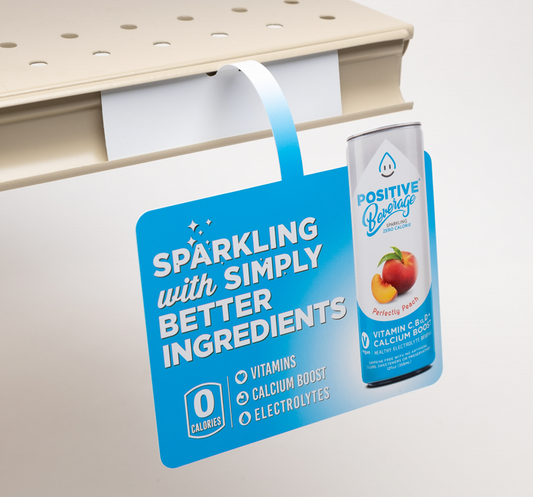 Custom printed retail shelf dangler and wobbler with double-sided tape for easy installation.