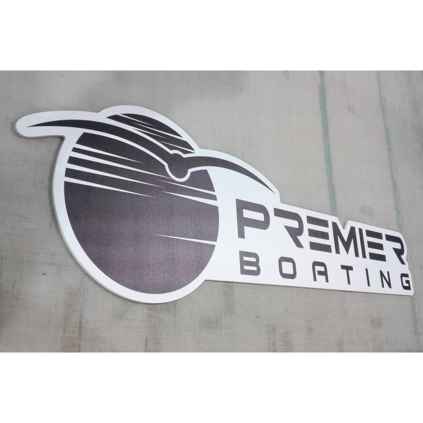 Custom contour-cut business signage ready for mounting at a corporate event.