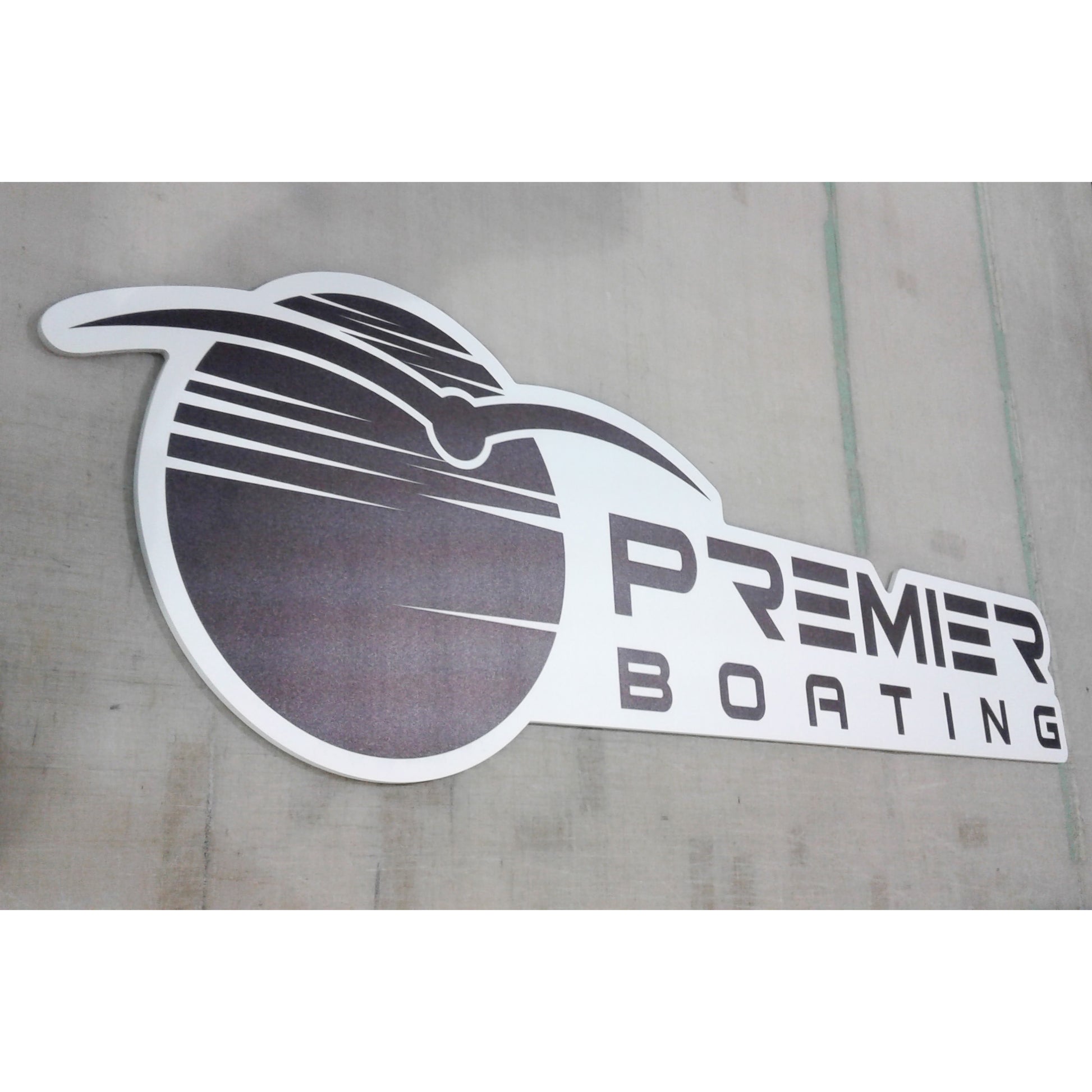 Custom contour-cut business signage ready for mounting at a corporate event.